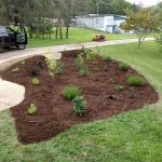 Newly installed mulch next to a driveway